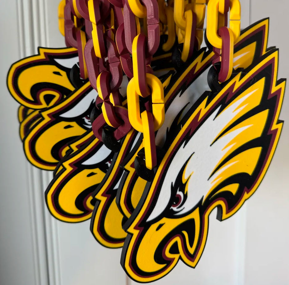 Dover-Eyota Eagles team order — a batch of 3D-printed hype chains hanging ready to ship
